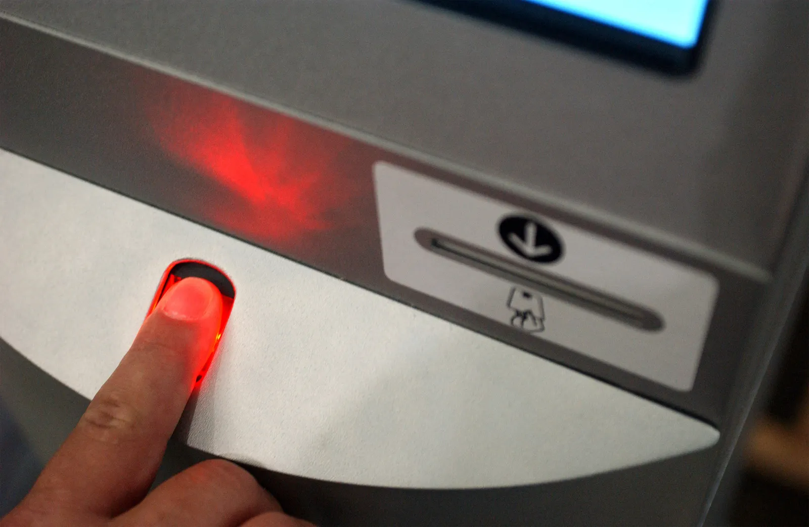Finger taps airport biometric scanner