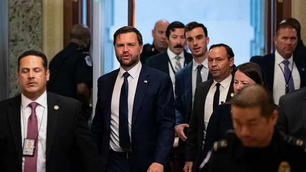 JD Vance walks out of a metal detector at the U.S. Capitol.