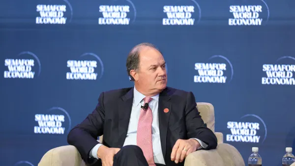 A person sits on stage at an event