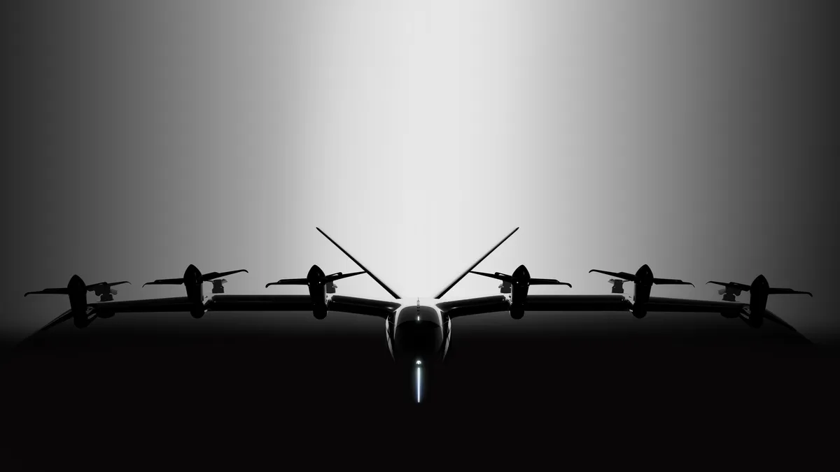 An electric vertical takeoff and landing aircraft is silhouetted against a gray background.