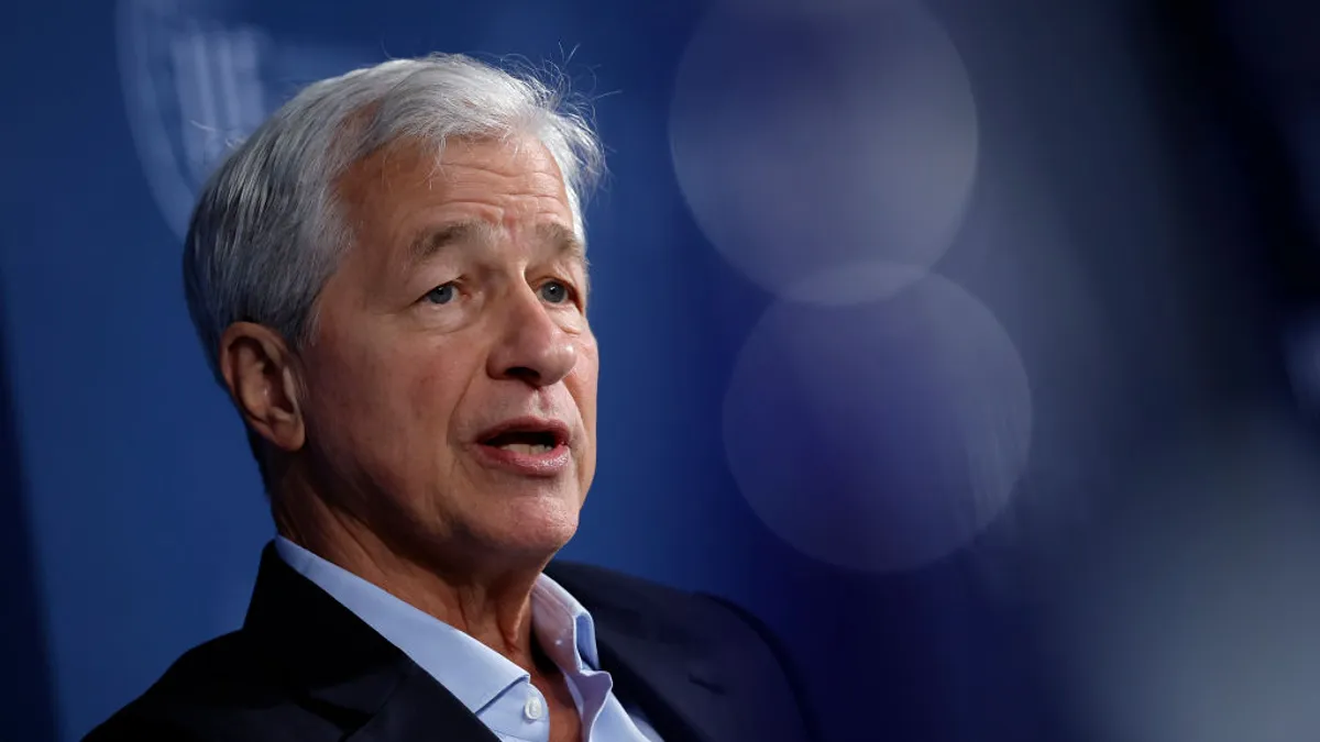 The CEO of JPMorgan Chase, Jamie Dimon, speaks in front of a blue background