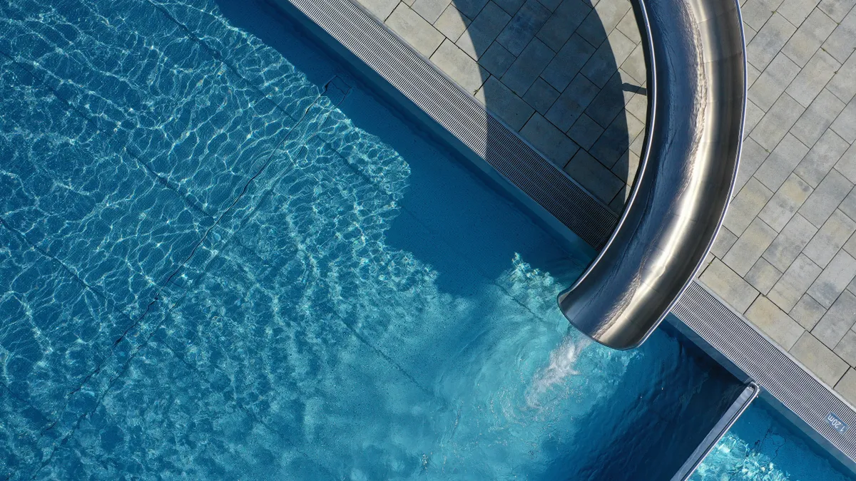 A waterslide empties into a pool.