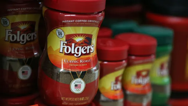 Packages of Folgers coffee on a grocery store shelf.