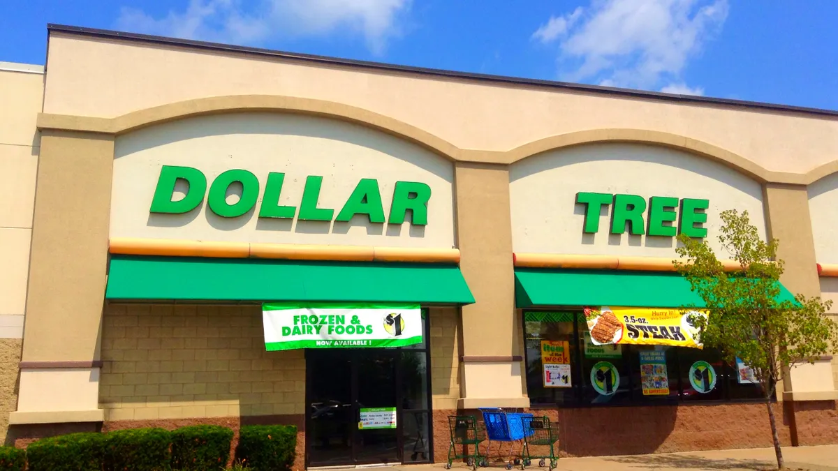 A dollar store with empty carts out front and blue skies above.