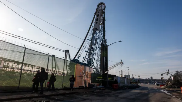 People walk past a worksite for the Gateway Hudson Tunnel on February 16, 2026, in New York City.