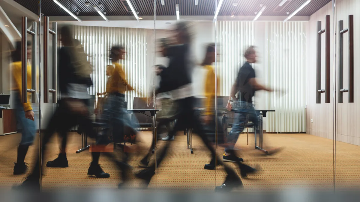 Businesspeople walking at modern office.