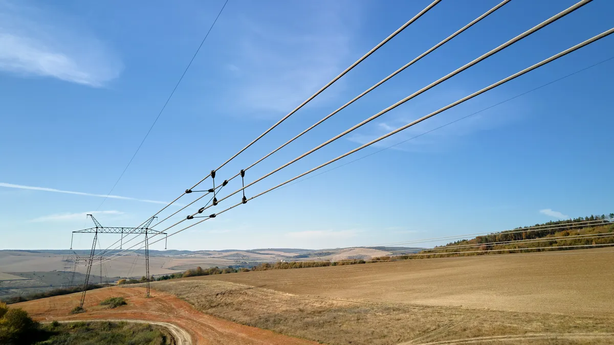 Steel pillar with high voltage electric power lines delivering electrical energy through cable wires on long distance.