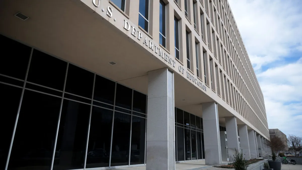 The camera shows the exterior of an off-white stone building with the working "U.S. Department of Education" on the side of the building