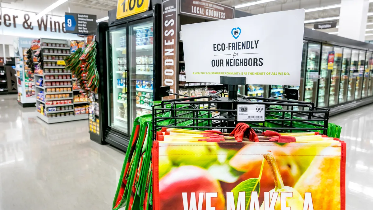 Inside a store, a sign above bags says "Eco-friendly for our neighbors."