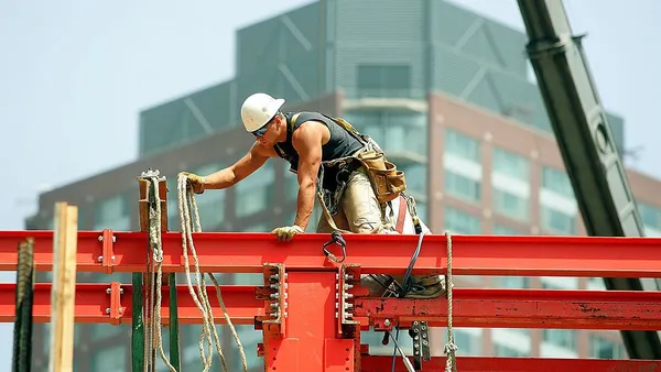With a new condo in the background, a worker is seen working on a new condo under construction in the new "Eastside" area of Chicago, Illinois.