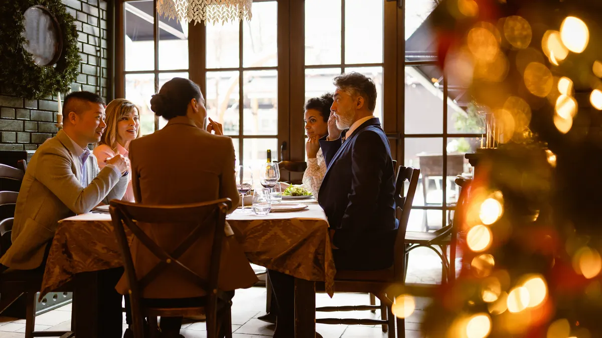 Business people having dinner in around Christmas time.