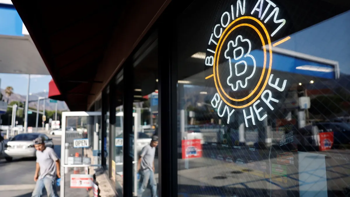 A sign advertises a Bitcoin ATM