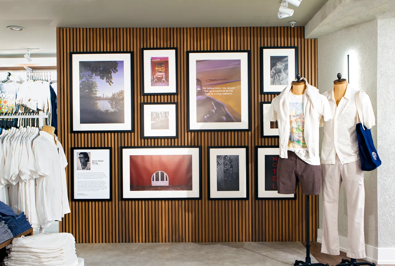 Mannequins grouped together in front of a wall with wood details.