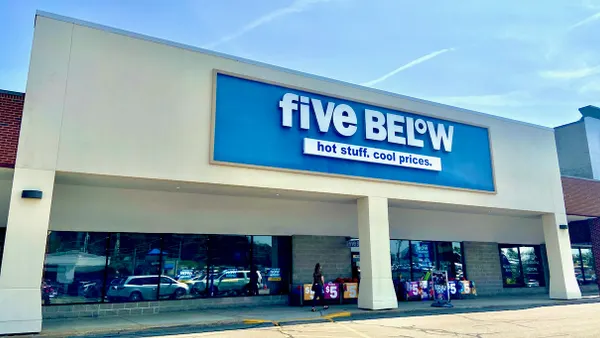 A person walks toward a store entrance.