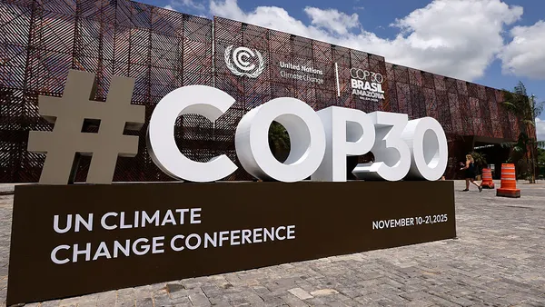 The COP30 logo is seen in front of a building.