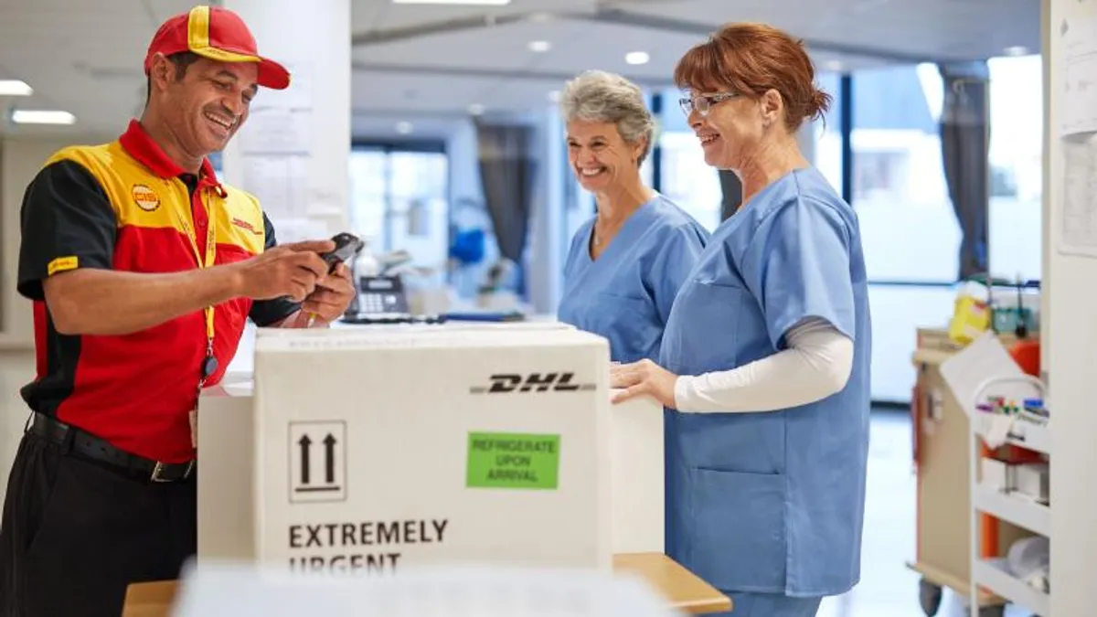 A DHL employee makes a delivery.