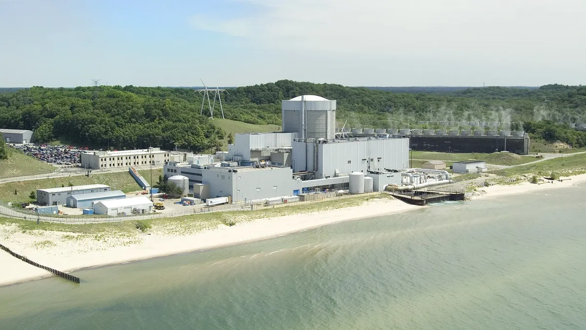 A nuclear power plant at the edge of a lake.