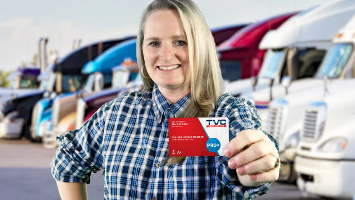 A photo of a person holding a membership card for TCV Pro-Driver.