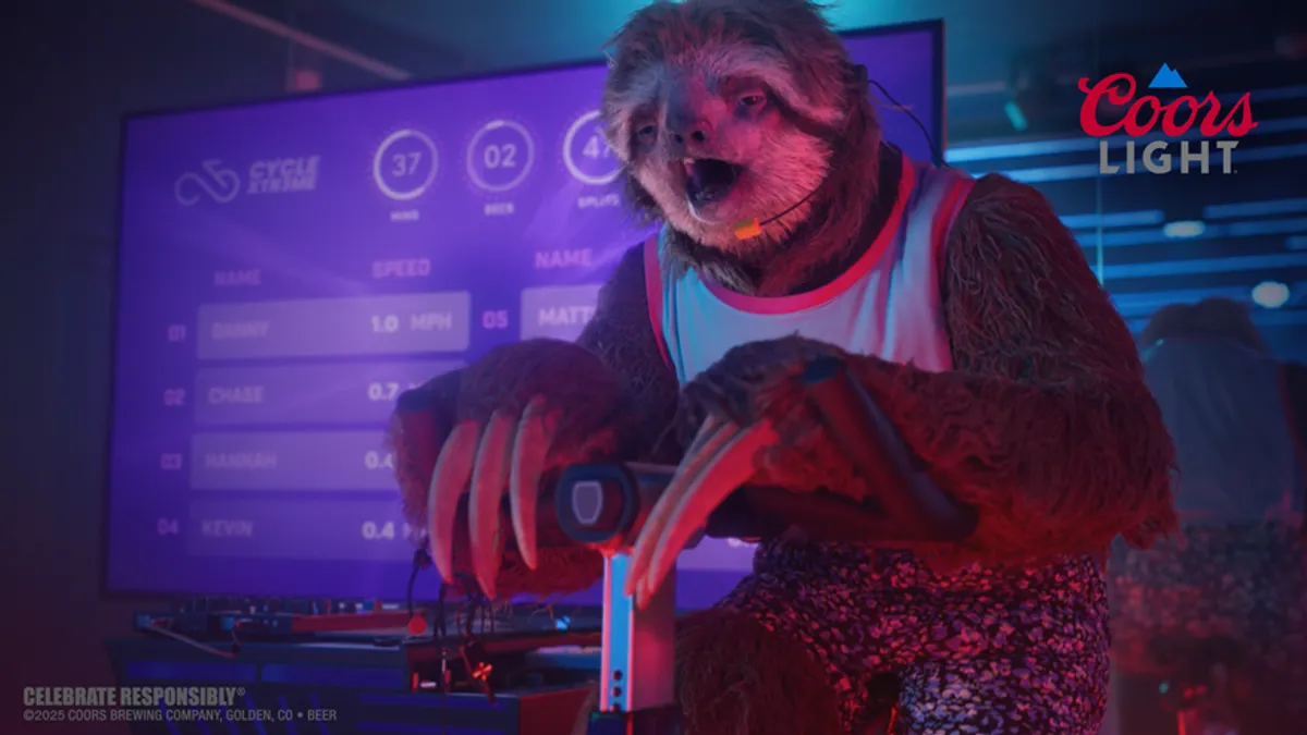 A sloth sits on a spin bike.