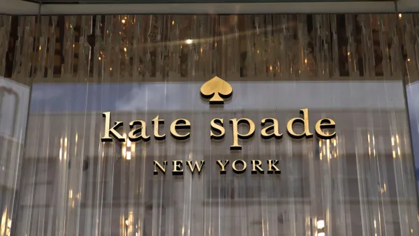 The Kate Spade logo is seen on a storefront.