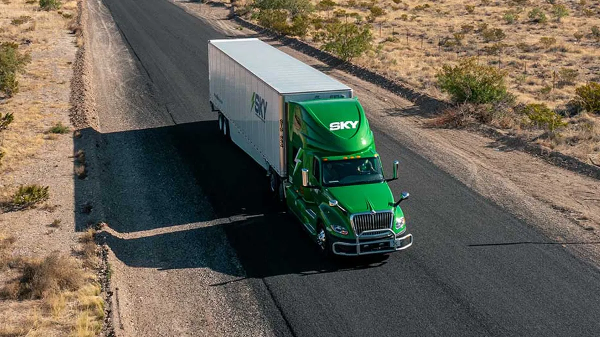 A Sky Transportation Services truck on the roadway.