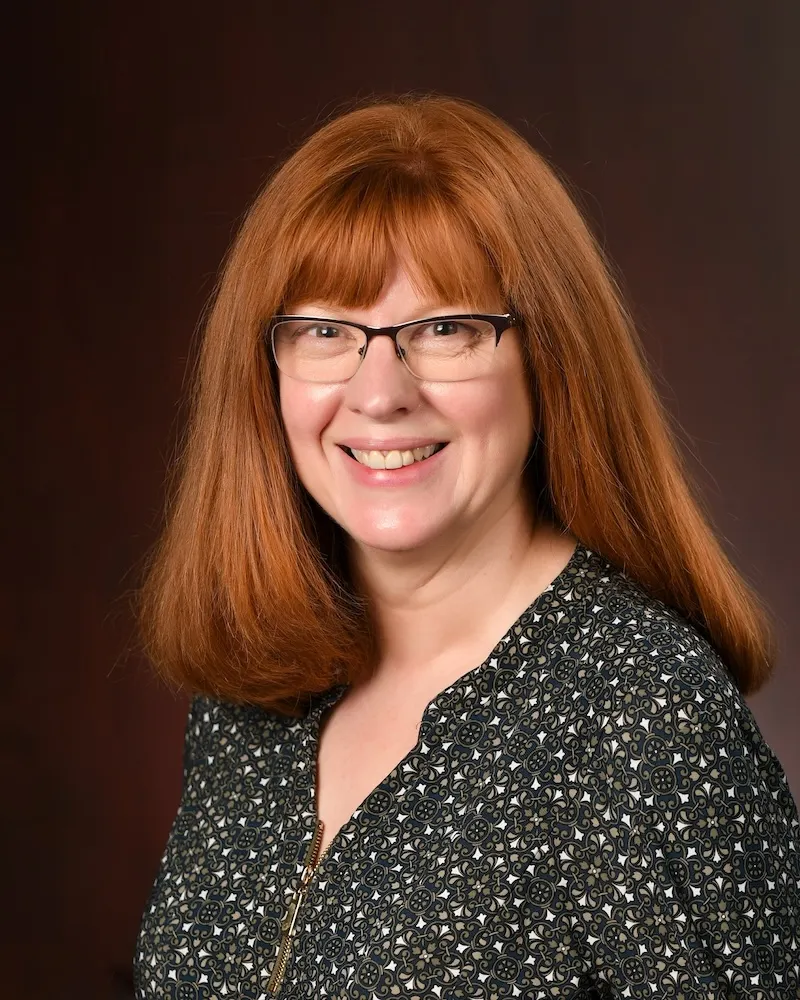 Person with glasses and long red hair.