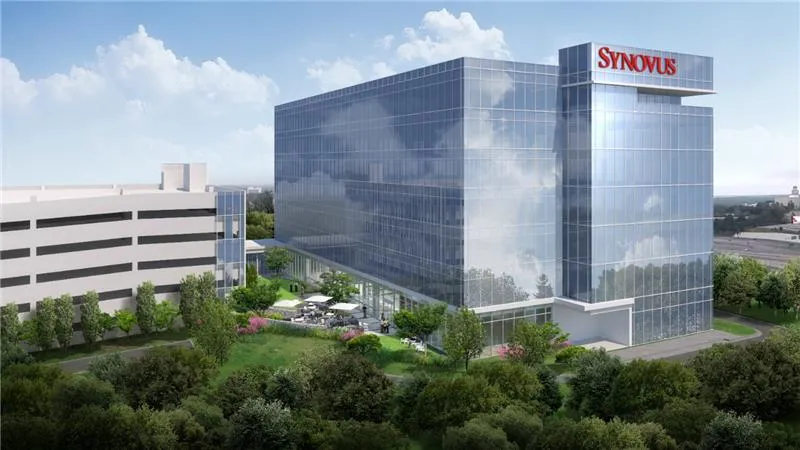 a large shiny office building with the word SYNOVUS written on top, surrounded by trees