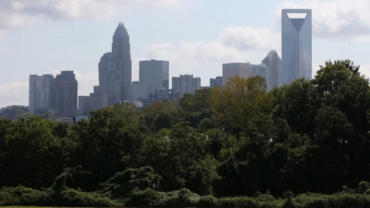 The skyline of downtown Charlotte is seen from a park