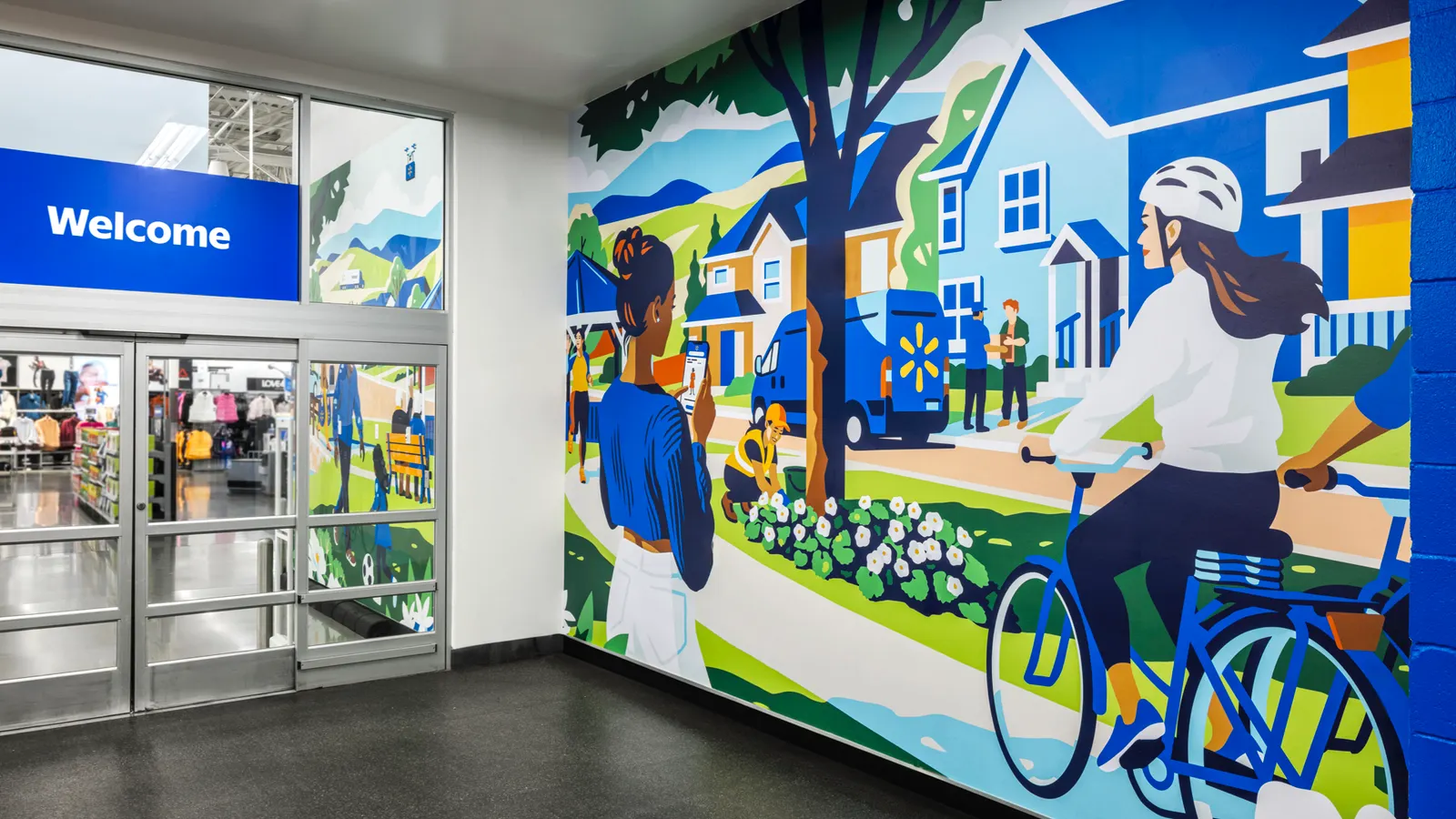 The vestibule of a Walmart displays a full-color illustrated mural depicting an idyllic neighborhood scene.