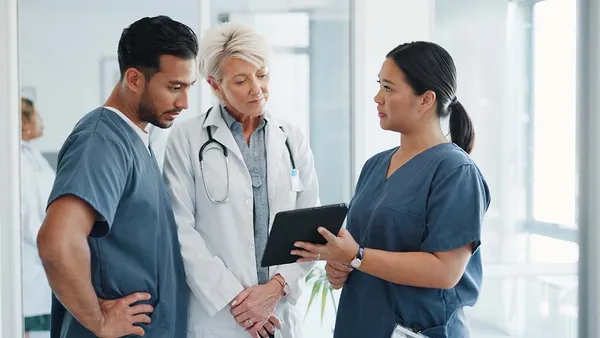 Doctor, team and tablet in discussion with senior for healthcare training, advise or support at hospital.