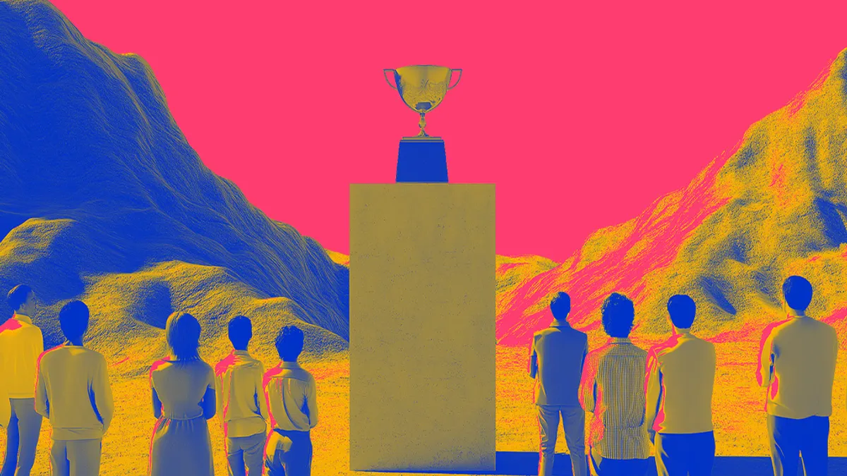 Group of people looking up at a trophy on display