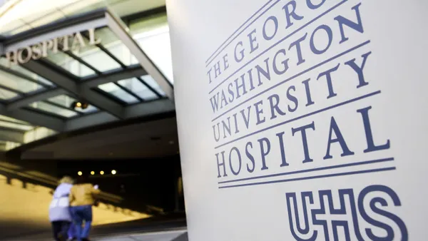 The sign in front of George Washington University Hospital, beside UHS' logo