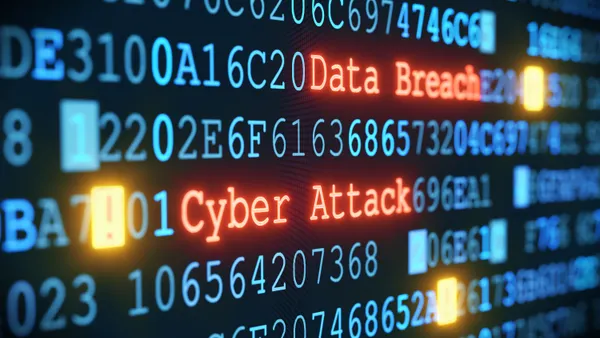 A close-up on an abstract design of a computer display warning of a cyber attack and flashing the words "data breach."