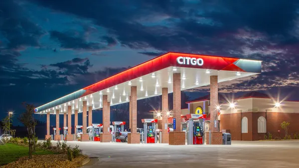 A photo of the outside of a gas station and convenience store. A sign on the canopy says Citgo while a sign on the store says Sunstate Oil.