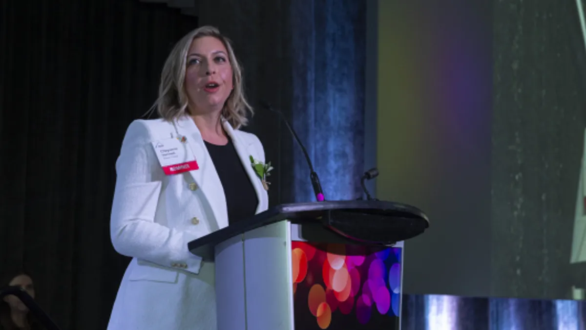 A woman talks at a lectern