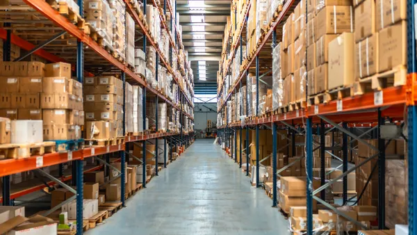 Interior view of an aisle of a distribution warehouse full of packages.