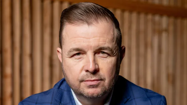 A photograph of a person with a blue suit