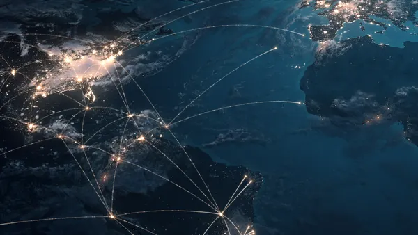 A three-dimension rendered image of global connection lines across a satellite image of earth