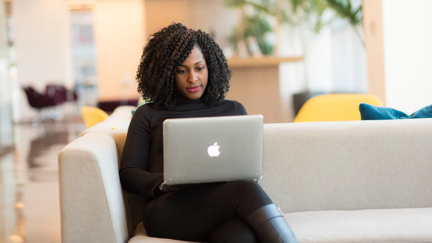 A Black woman uses her laptop