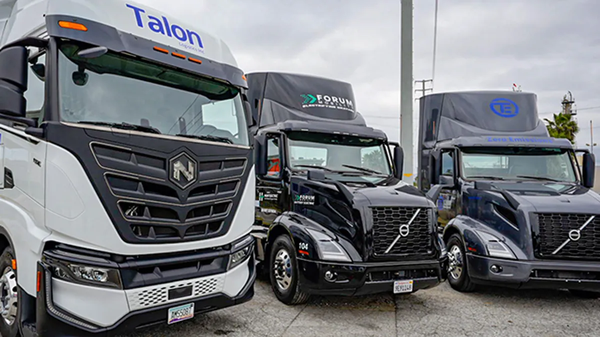 The frontal view of three electric trucks.