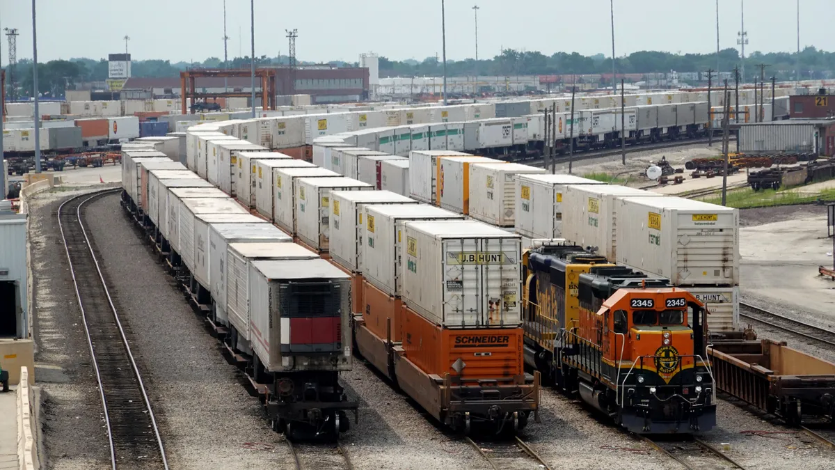 J.B. Hunt shipping containers are stacked on a BNSF train.