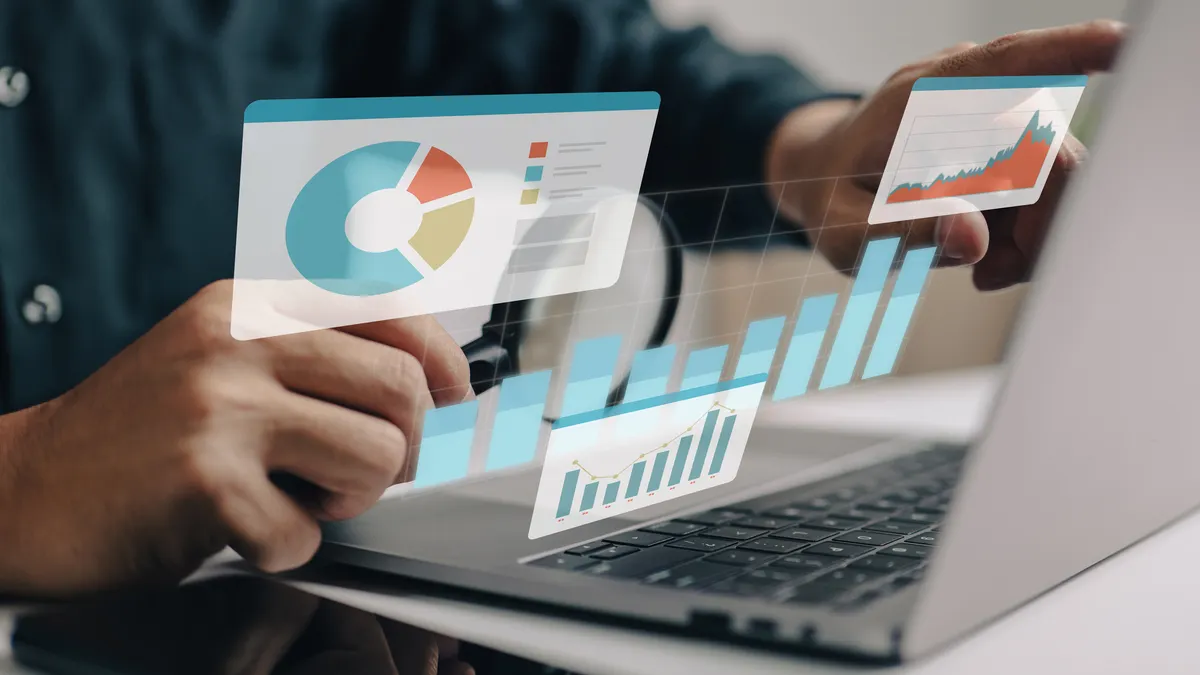Businesspeople working on a monitor graph dashboard while performing statistical and data analysis for corporate finance and investment ideas.