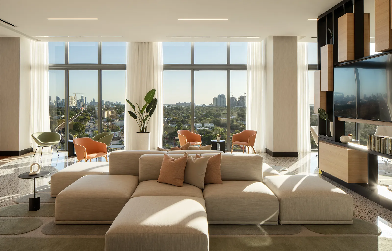 An apartment lounge with a white couch.