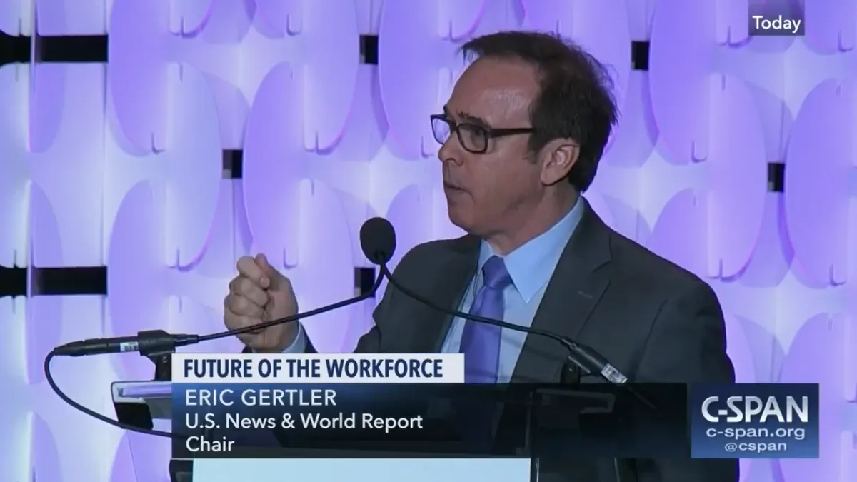 Eric Gertler, executive chair and CEO of U.S. News & World Report, speaks at a conference.