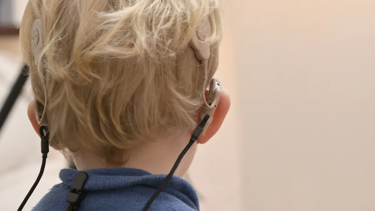 A boy with hearing aids and cochlear implants