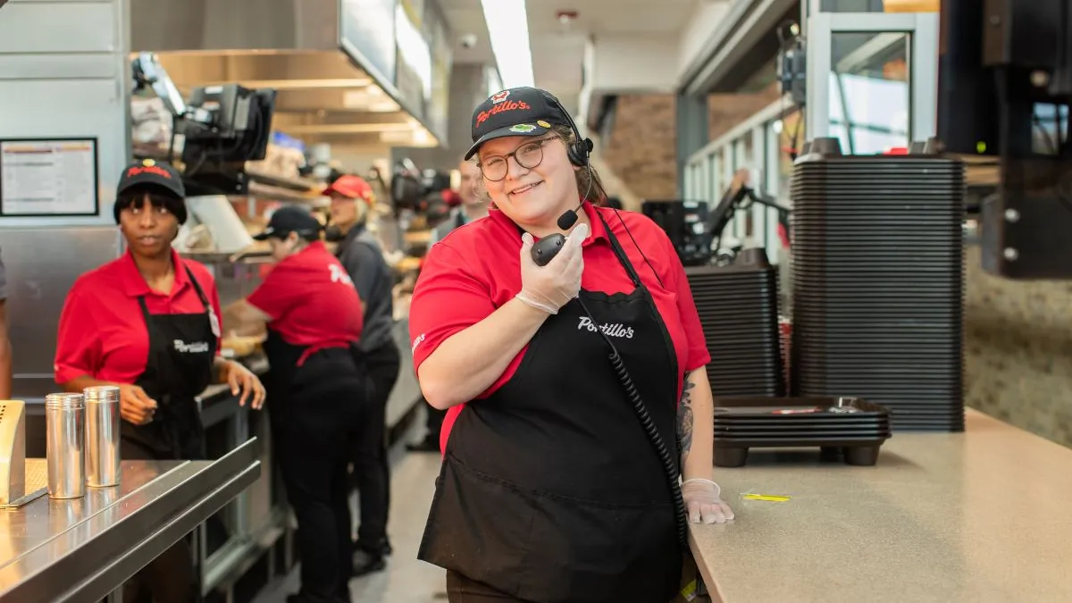 Portillo's team member holds a loud speaker announcing an order is ready