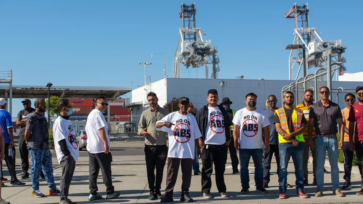 Owner-operators create a protest line in front of the TraPac parking lot before the night shift on Monday, July 18.