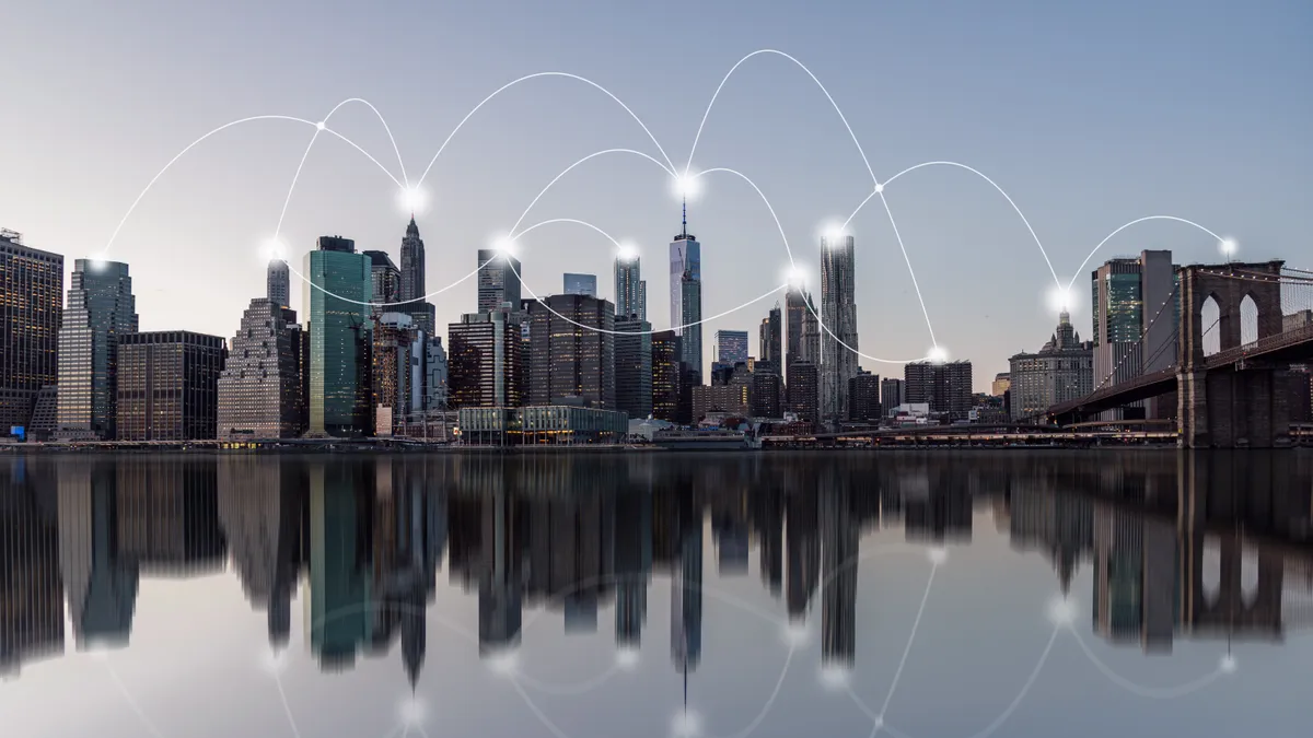 City skyline and reflection in water with white curved lines connecting buildings