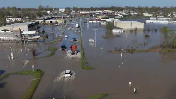 Aerial view of tornadoes driving through flooded street