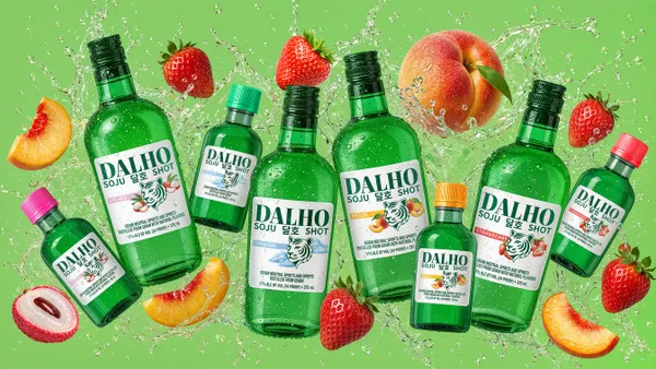 Bottles of varying sizes of Dalho, a soju brand from Sazerac. The bottles are surrounded with fruits.